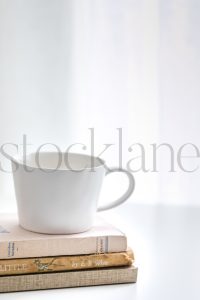 Vertical stock photo of coffee cup and books