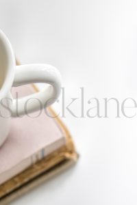 Vertical stock photo of coffee cup and books