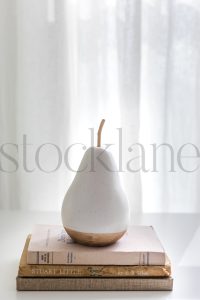 Vertical stock photo of book and pear