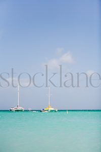 Vertical stock photo of boats in the Caribbean