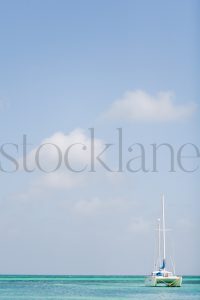 Vertical stock photo of boat in blue water