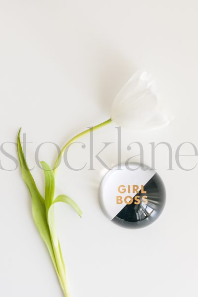 Vertical stock photo of paper weight and flower