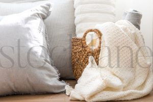 Horizontal image of pillows and basket with blankets