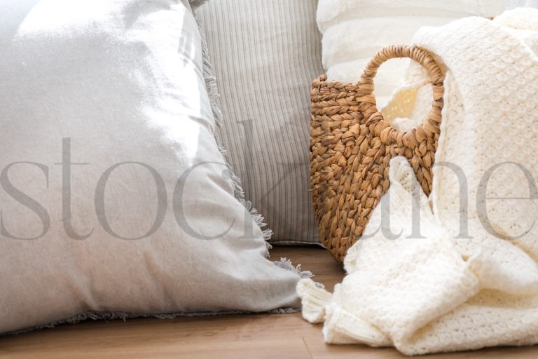 Horizontal photo of pillows and basket with blankets