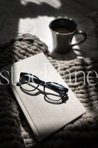 Vertical stock photo of book and glasses