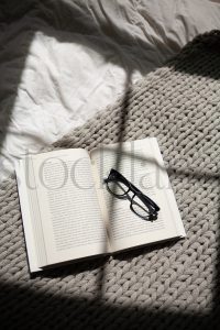 Vertical stock photo of book and glasses