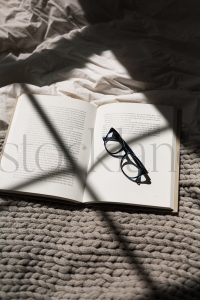 Vertical stock photo of book and glasses