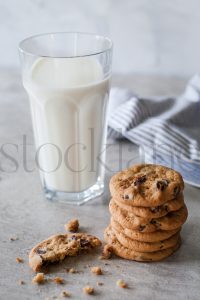 Vertical stock photo of milk and cookies