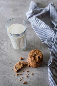 Vertical stock photo of milk and cookies