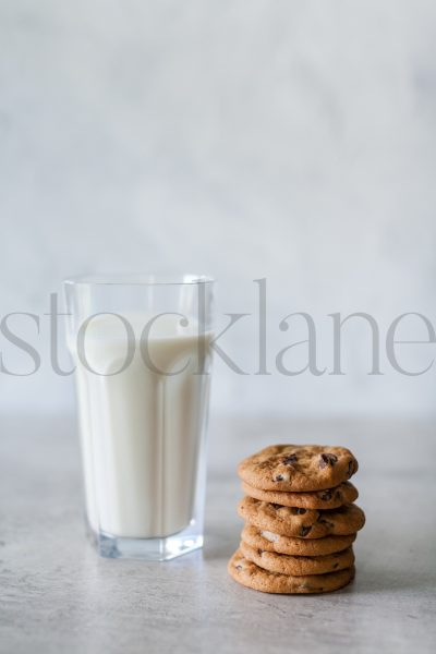 Vertical stock photo of milk and cookies