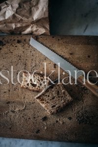 Vertical stock photo of cutting bread