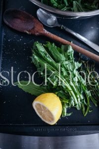 Vertical stock photo of greens and lemon