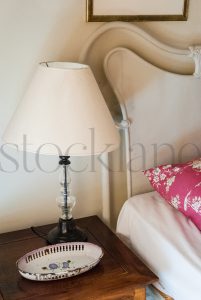 Vertical Stock photo of nightstand and bed