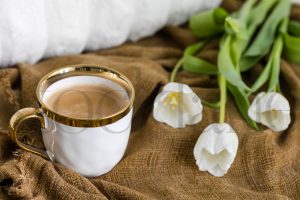 Horizontal stock photo of coffee cup and tulips