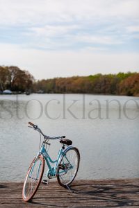 Vertical Stock photo of a bicycle by a river