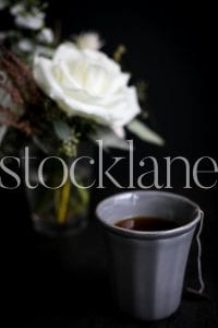 Vertical stock photo of tea and white flower