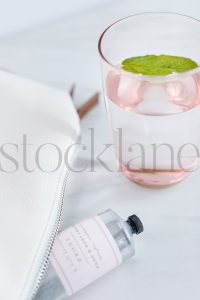 Vertical Stock photo of glass of mint water and lotion