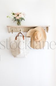 Vertical stock photo of hat, bag, on a coat rack