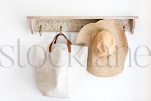 Horizontal stock photo of hat, bag, on a coat rack