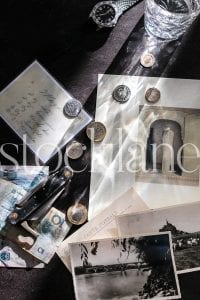 Vertical stock photo of coins, notes, and pocket knife