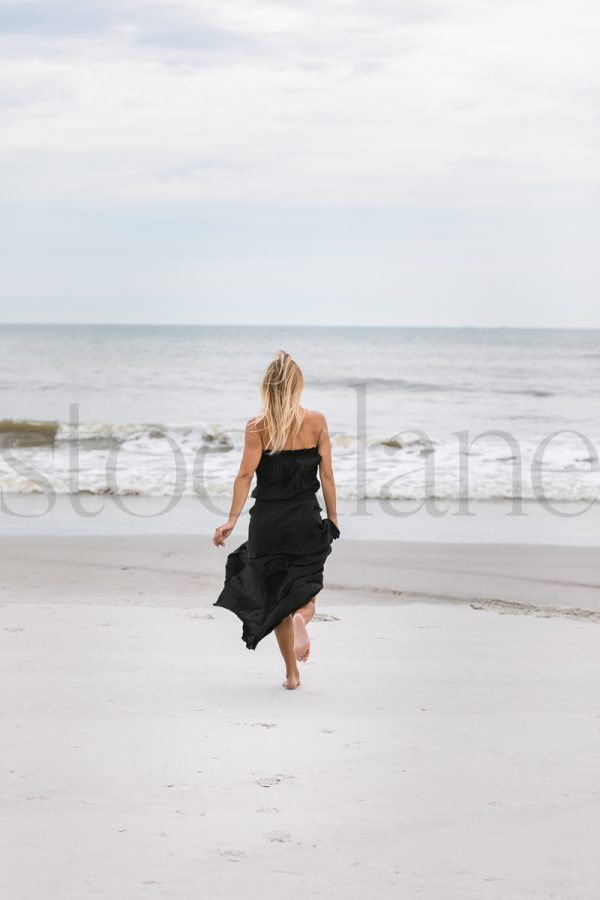 Vertical stock photo of woman at the beach