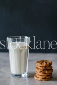 Vertical stock photo of milk and cookies