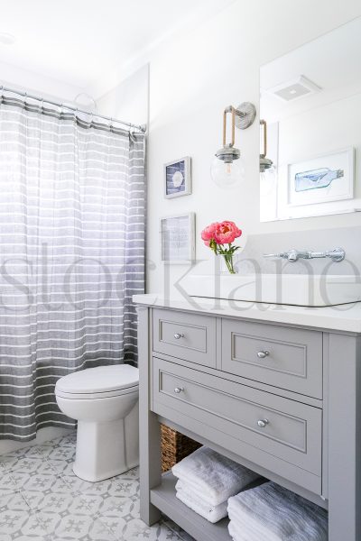 Vertical photo of peonies in a vase in a bathroom