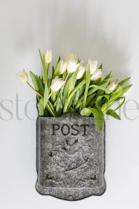 Vertical stock photo of flowers in mailbox