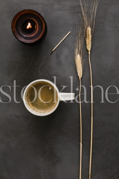 Vertical stock photo of fall themed coffee with candle