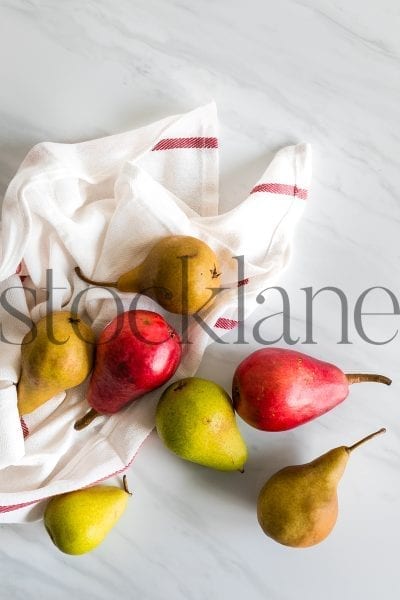 Vertical stock photo of pears on kitchen countertop