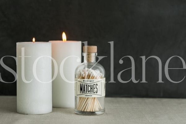 Horizontal stock photo of white candles and matches