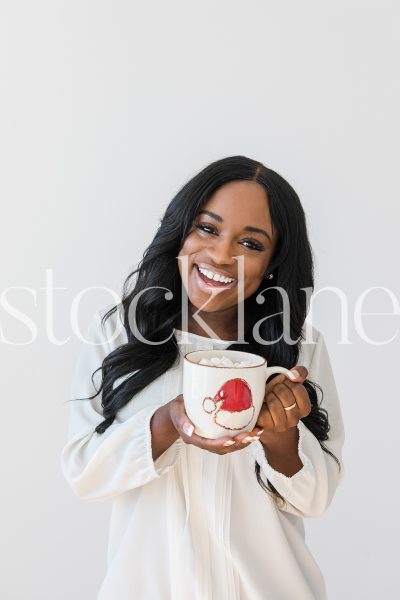 Vertical stock photo of woman holding hot cocoa