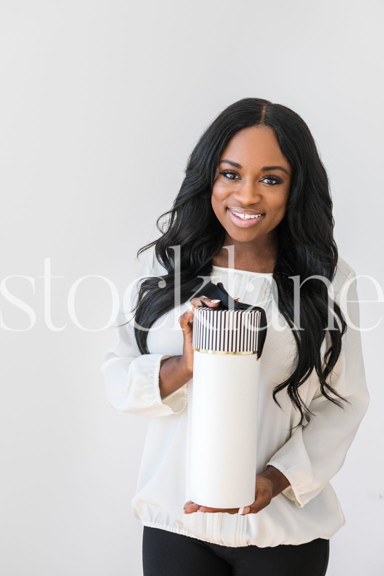 Vertical stock photo of woman holding gift