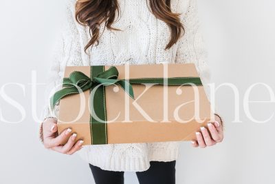 Horizontal stock photo of woman holding gift