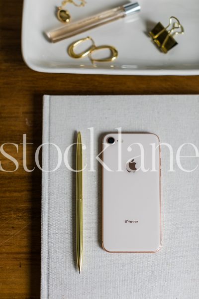 Vertical stock photo of notebook, pen and phone