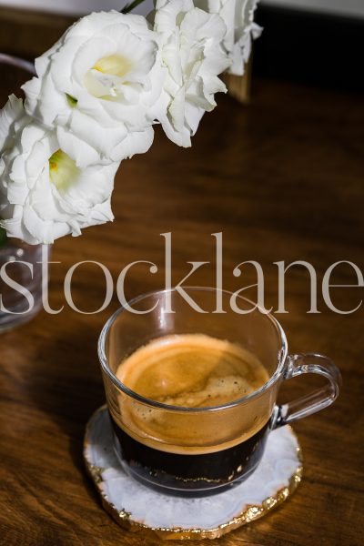 Vertical stock photo of coffee cup with white flowers