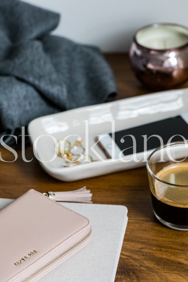 Vertical stock photo of desk with wallet and phone