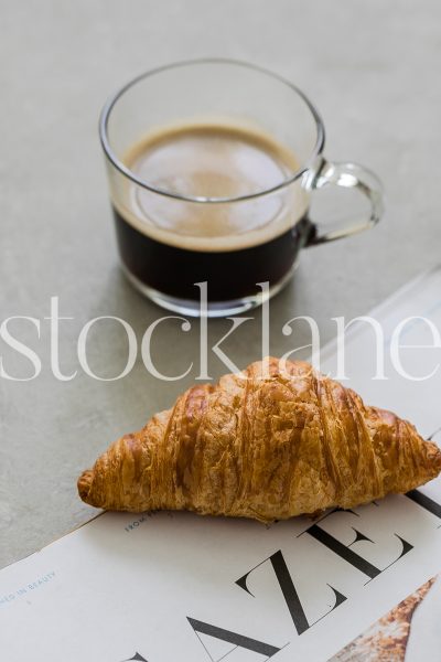 Vertical stock photo of coffee and croissant