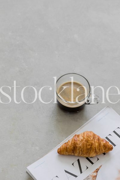 Vertical stock photo of coffee and croissant