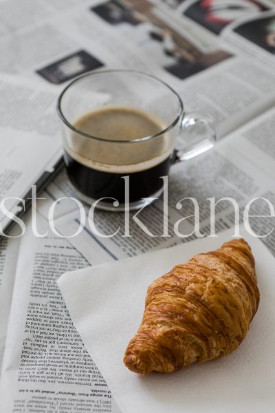 Vertical stock photo of coffee and croissant