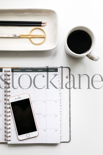 Vertical stock photo of journal with phone and coffee