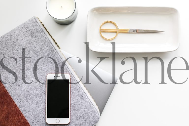 Horizontal stock photo of desk with computer and iPhone