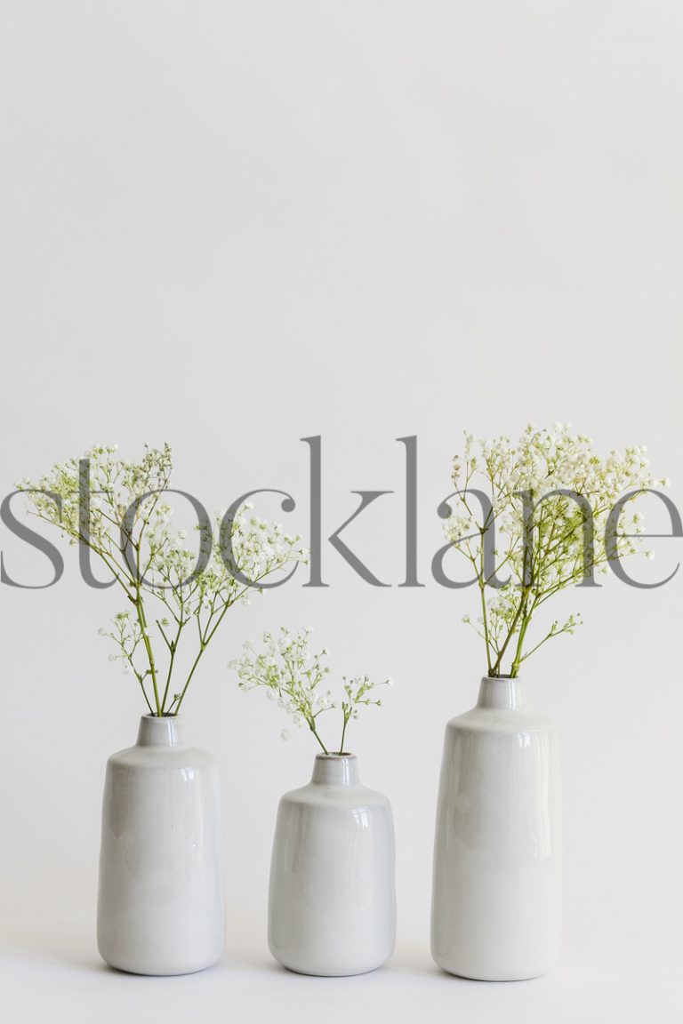 Vertical stock photo of 3 vases with flowers