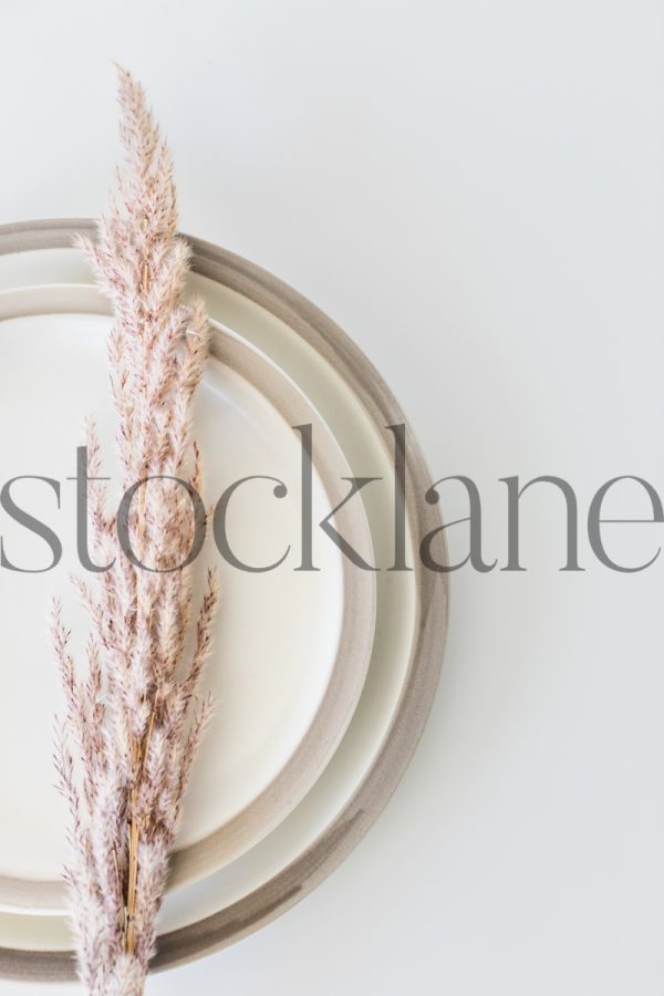 Vertical stock photo of neutral place setting with pink detail