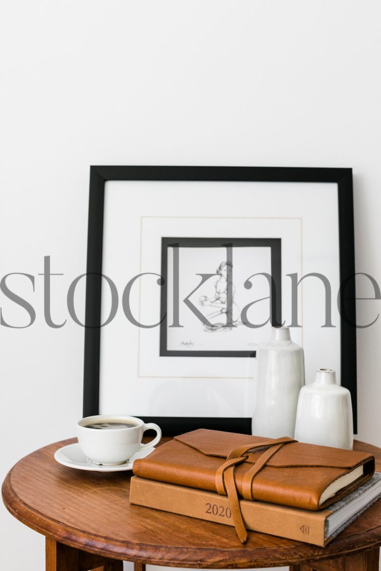 Vertical stock photo of table with coffee and notebooks