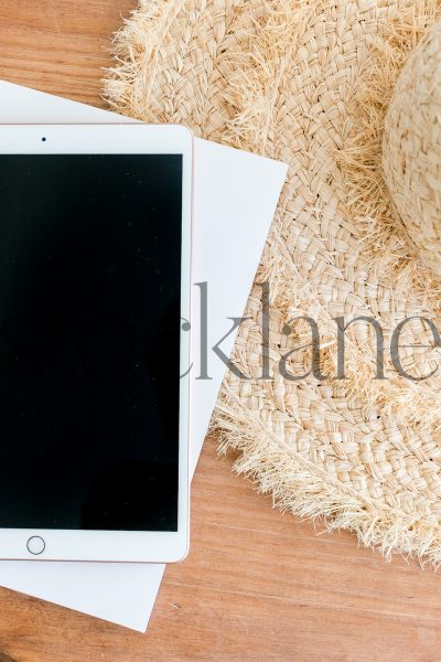 Vertical stock photo of iPad and hat