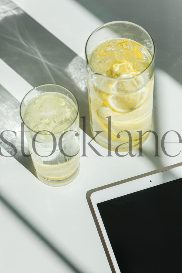 Vertical stock photo of iPad and lemon water