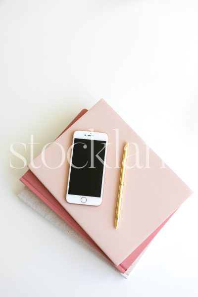 Vertical stock photo of pink colored notebooks