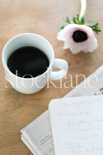 Vertical stock photo of coffee and newspaper