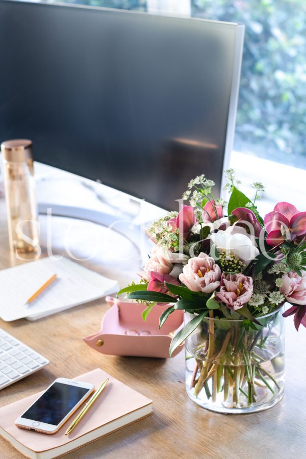 Vertical stock photo of feminine desktop